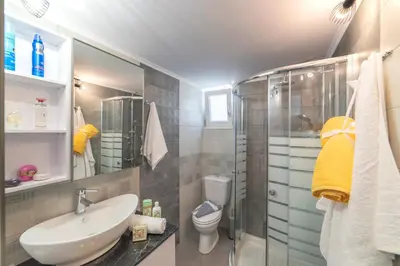 a bathroom with a sink and a shower and a toilet at Chania Design Suites in Chania Town