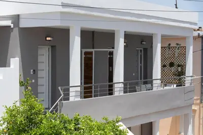 a house with a balcony in front of it at Chania Design Suites in Chania Town