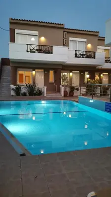a house with a swimming pool in front of a house at Okeanis II in Kato Daratso