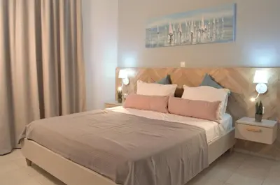 a bedroom with a large bed with two night stands at Notos Villas in Frangokastello