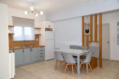 a kitchen with a table and chairs in a room at Notos Villas in Frangokastello