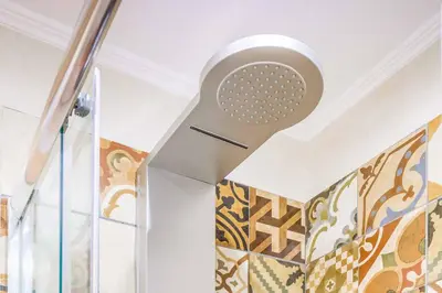 a shower in a room with a wall at Villa Elenitsa in Nopíyia