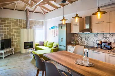 a kitchen and living room with a table and chairs at Villa Elenitsa in Nopíyia