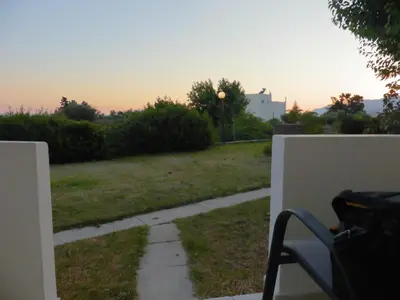 a view of a yard with a bench on a porch at Ledakis Studios in Frangokastello