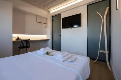 a bedroom with a white bed with towels on it at Hanim Boutique Hotel in Chania Town