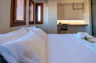 a white bed with towels sitting on top of it at Hanim Boutique Hotel in Chania Town