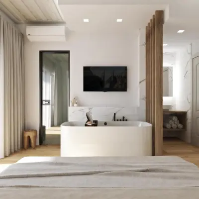a bedroom with a white tub and a tv on the wall at Hanim Boutique Hotel in Chania Town
