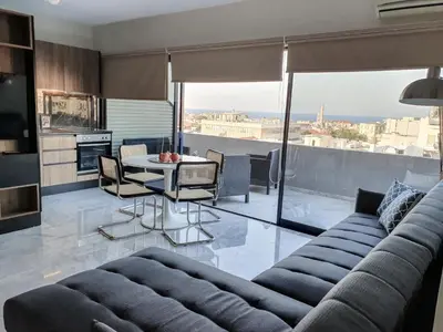 a living room with a couch and a table at Sigma city loft, in the heart of Chania in Chania Town