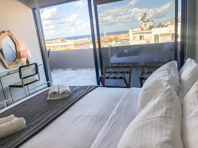a bed with a pair of sandals sitting on top of it at Sigma city loft, in the heart of Chania in Chania Town