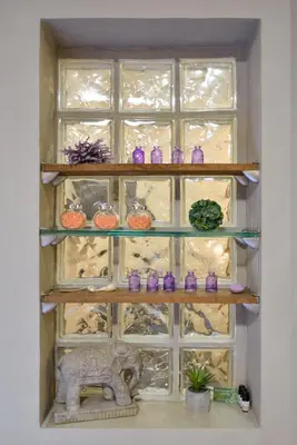 a shelf with purple glass vases and an elephant at Thalassa mou Seafront suite in Chania Town