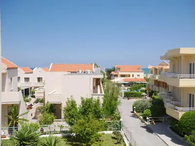 a view from the balcony of a apartment building at Litinas Apartments with pool in Agia Marina Nea Kydonias