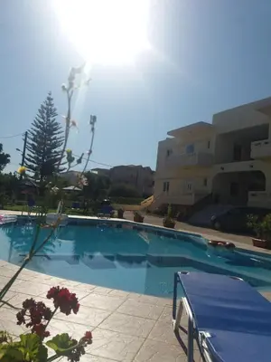 a large swimming pool in front of a building at Litinas Apartments with pool in Agia Marina Nea Kydonias