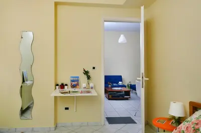 a room with a door open to a room with a table at Sweet Home Lena Feel like home in Chania Town