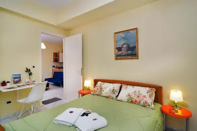 a bedroom with a green bed with two towels on it at Sweet Home Lena Feel like home in Chania Town