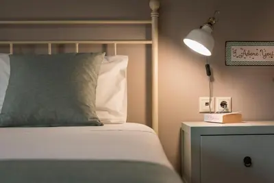a bed with a pillow and a lamp on a night stand at BOUTIQUE VILLA PETRA AMANDA Heated pool optional in Fílippos