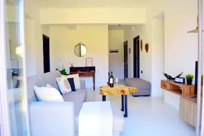 a living room with a couch and a table at Ocean Breeze Apartments in Gerani Chanion
