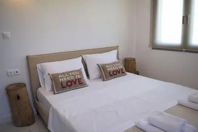 a bedroom with a bed with two pillows at Ocean Breeze Apartments in Gerani Chanion