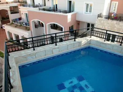 a large swimming pool in front of a building at Alexandra Beach Hotel in Agia Marina Nea Kydonias