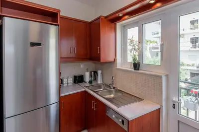 a kitchen with a stainless steel refrigerator and a sink at Voula's Place in Chania Town