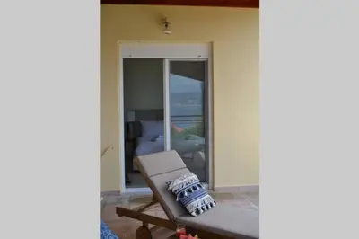 a living room with a couch and a view of the ocean at Villa Melpomeni in Sinoikismós Plakálona