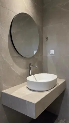 a bathroom sink with a mirror on a counter at Mesohori studios in Sfakiá