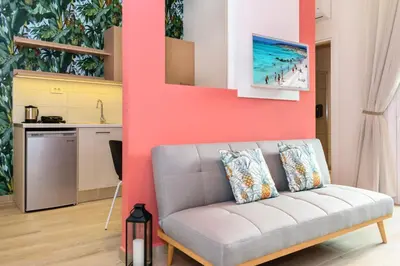 a living room with a couch and a kitchen at Iliana Apartments in Falasarna