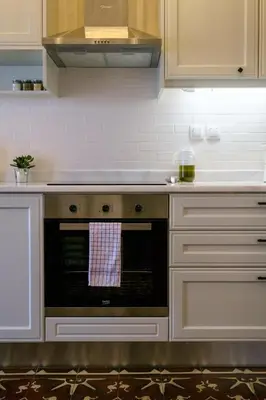 a kitchen with a stove with a towel on the oven at Grandma's Chic Home in Chania Venetian Harbor in Chania Town