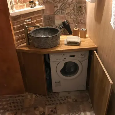 a bathroom with a sink and a washing machine at Aristokosmos in Chania Town