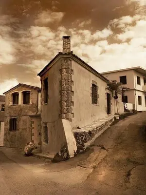 an old building sitting on the side of a street at Aristokosmos in Chania Town