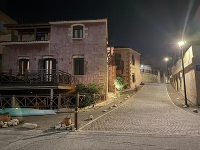 an empty street at night with a building at Aristokosmos in Chania Town