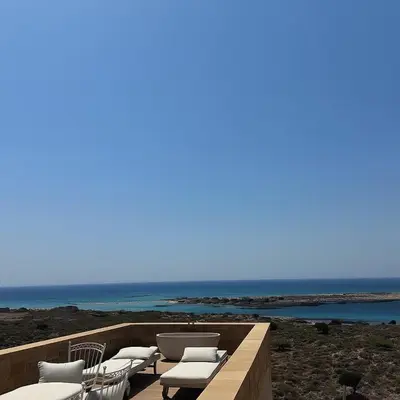a deck with chairs and a view of the ocean at Elafonisi Villa above the Beach in Elafonisi