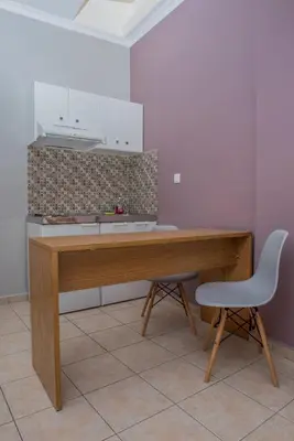 a kitchen with a wooden desk and a chair at Semeli Studios in Chania Town