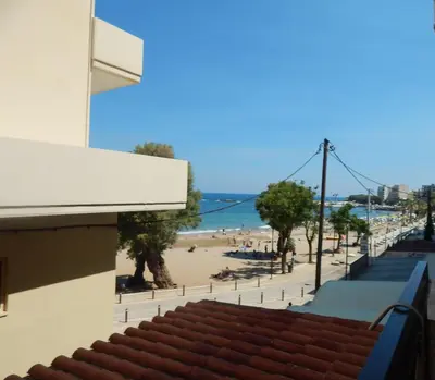 a view of the beach from the balcony of a building at Posidonio Hotel in Chania Town