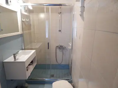a bathroom with a shower and a sink at Posidonio Hotel in Chania Town