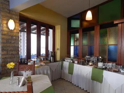 a restaurant with two tables with white table cloth at Posidonio Hotel in Chania Town