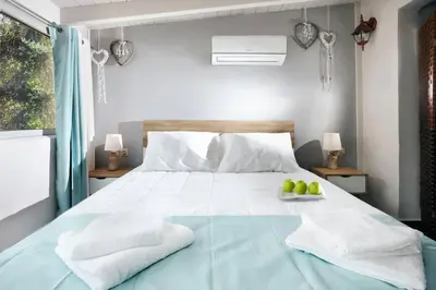 a bedroom with a bed with a bowl of apples on it at Chania Green House 2 in Aghii Apostoli