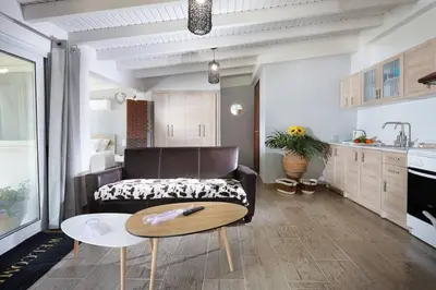 a living room with a couch and a table at Chania Green House 2 in Aghii Apostoli