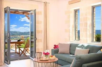 a living room with a couch and a table at Villa Vardis Heated Pool in Vryses