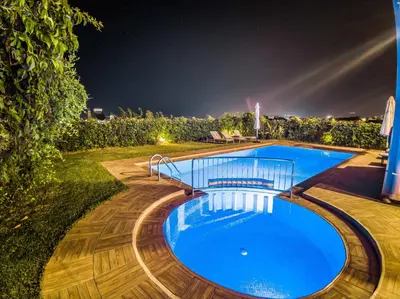 a swimming pool in a yard at night at Villa Panagiotis Chania in Daratso