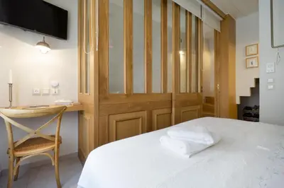 a bedroom with a bed with a desk and a chair at Kallinikou Residence - private parking on demand - in Chania Town