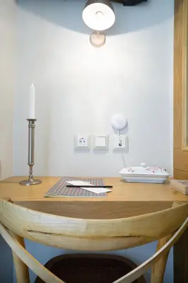 a wooden table with a candle on top of it at Kallinikou Residence - private parking on demand - in Chania Town