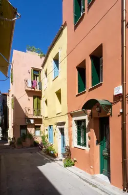 a building on a street in a city at Kallinikou Residence - private parking on demand - in Chania Town