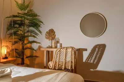 a bedroom with a bed and a table and a mirror at Palm Luxury Studios in Chania Town