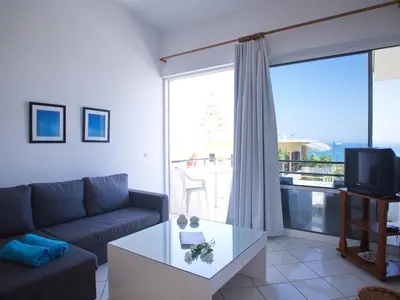 a living room with a couch and a table at Rouladina Apartments in Stalos