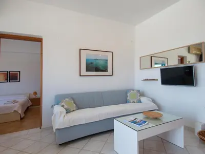 a living room with a couch and a table at Rouladina Apartments in Stalos