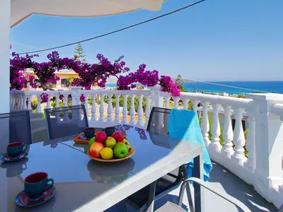 a bowl of fruit on a table on a balcony at Rouladina Apartments in Stalos