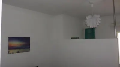 a white room with a picture and a chandelier at Summer Holidays Studio in Chania Town
