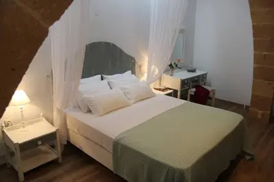 a bedroom with a large bed with white pillows at Charming villa in Chania with parking included in Kolymvari