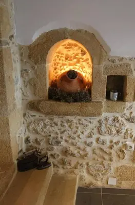 a stone oven with a pizza in it at Charming villa in Chania with parking included in Kolymvari