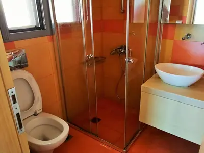 a bathroom with a toilet and a shower and a sink at Amoutsa Seaside Villa in Kolymvari